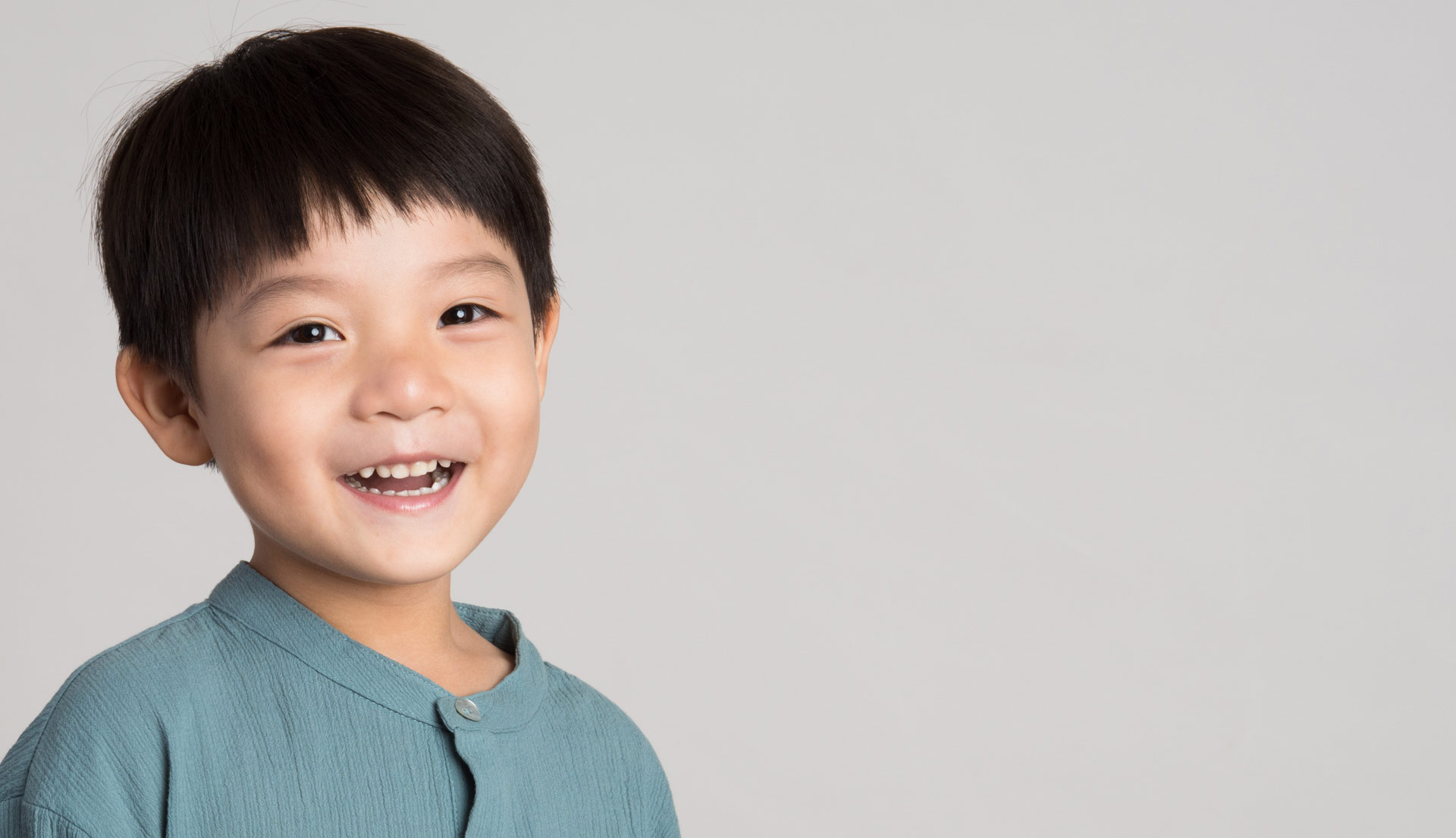 Young Asian American boy smiling with healthy teeth